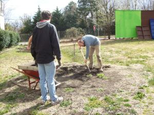 Farmlet manager and volunteer Allen Stambaugh turn soil for a new garden plot.